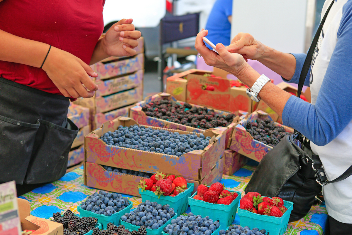 Fresh Baskets of Organically grown strawberries blackberries and blueberries for sale at the downtown farmers' market.