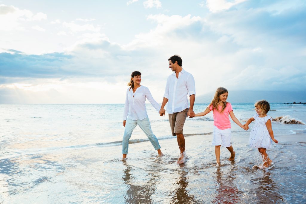 Happy Family Walking on the Beach
