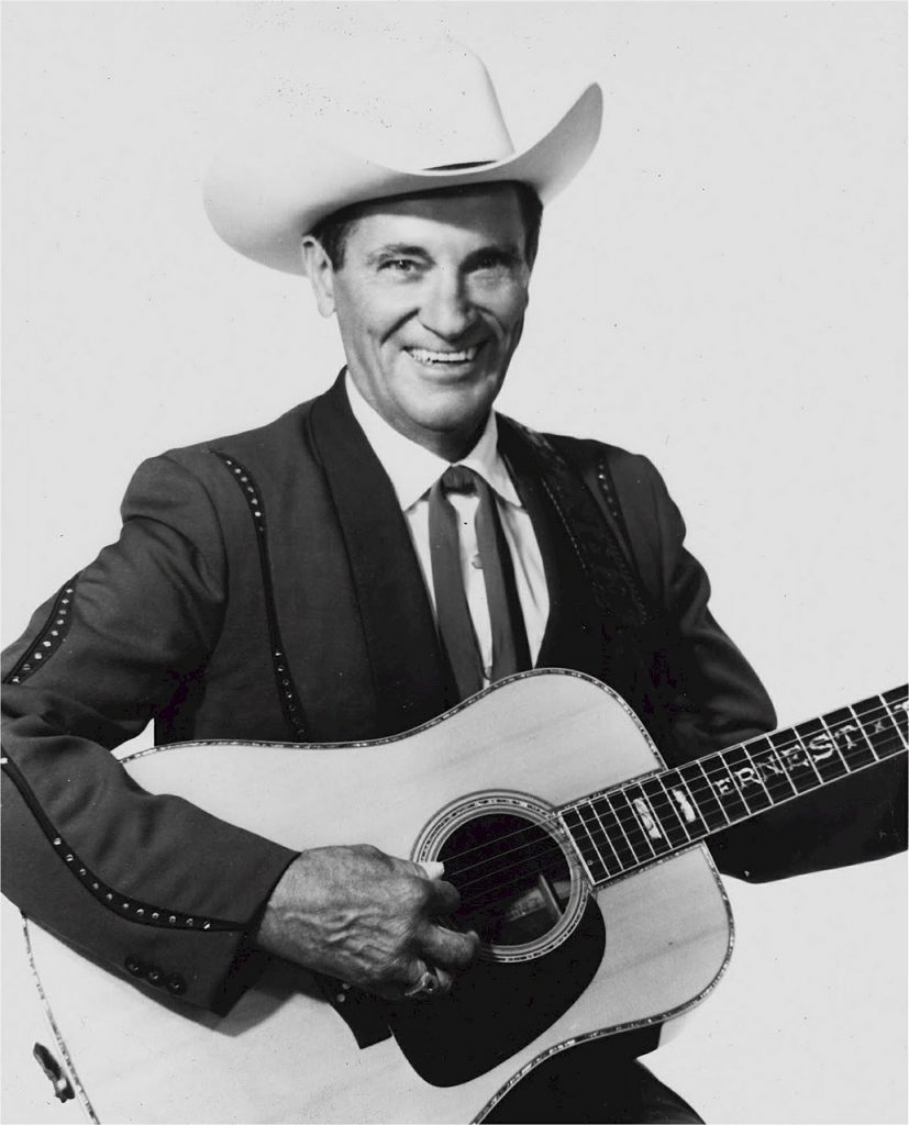 black and white photograph of country singer, Ernest Tubb, holding his guitar