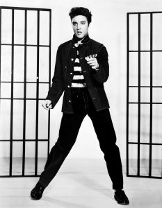 Black and white photograph of young Elvis Presley dancing