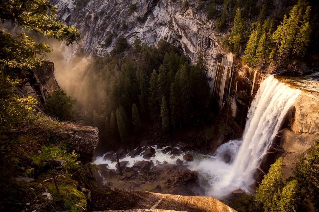 Yosemite Falls waterfall over rocks in California 