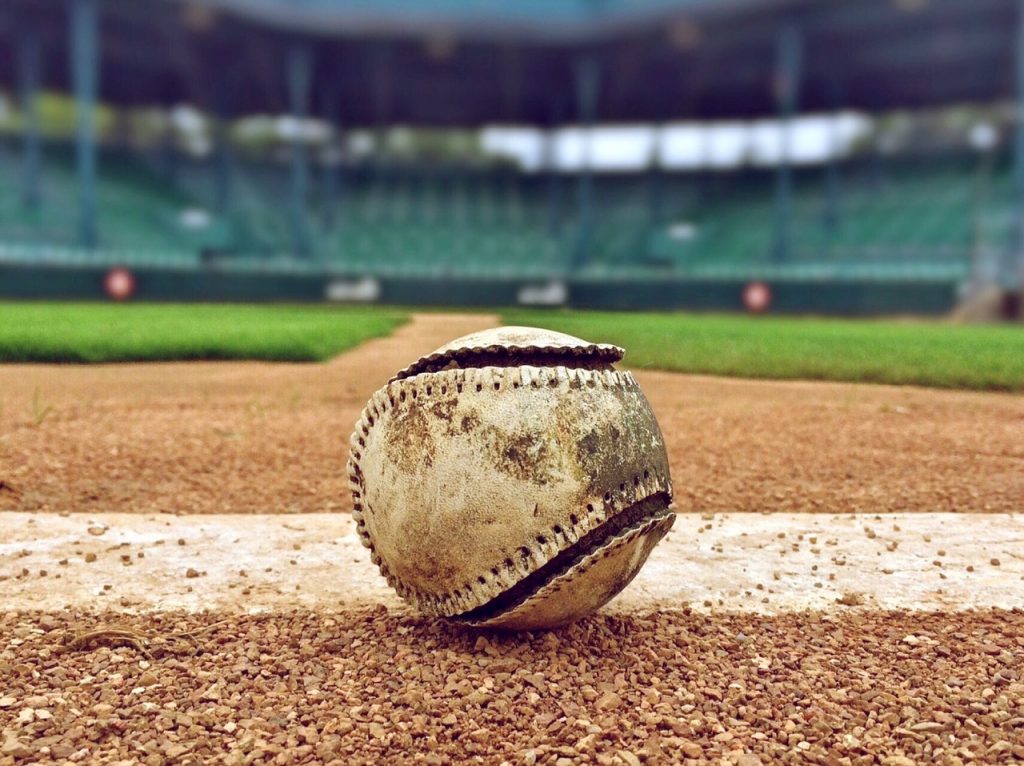 a tethered baseball sitting on a baseball field 