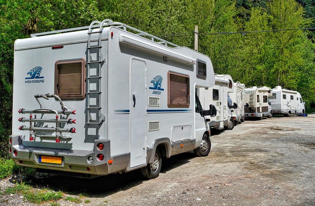 several rv's in a row in an rv campground
